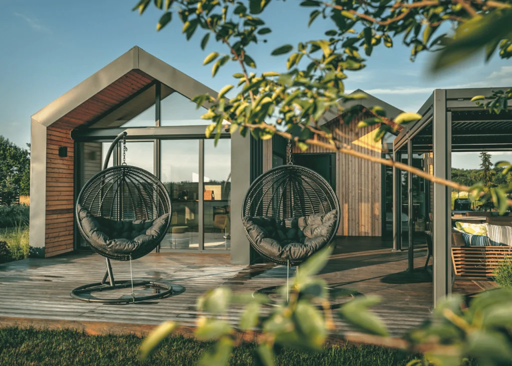 Tiny House in the Woods with Hanging Chairs and Wooden Deck