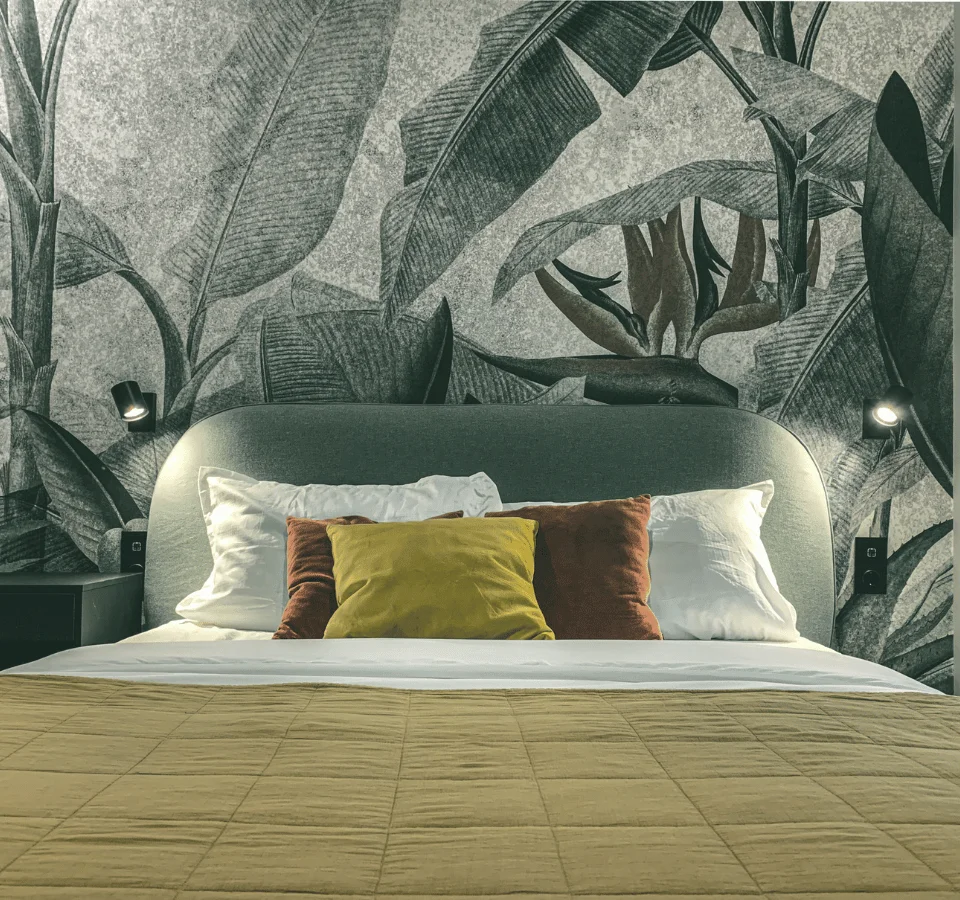 Tiny house stuga bedroom with printed wallpaper, cushions, duvet