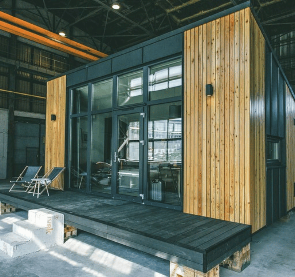 Tiny house construction in the factory, wood finishing, black wooden step