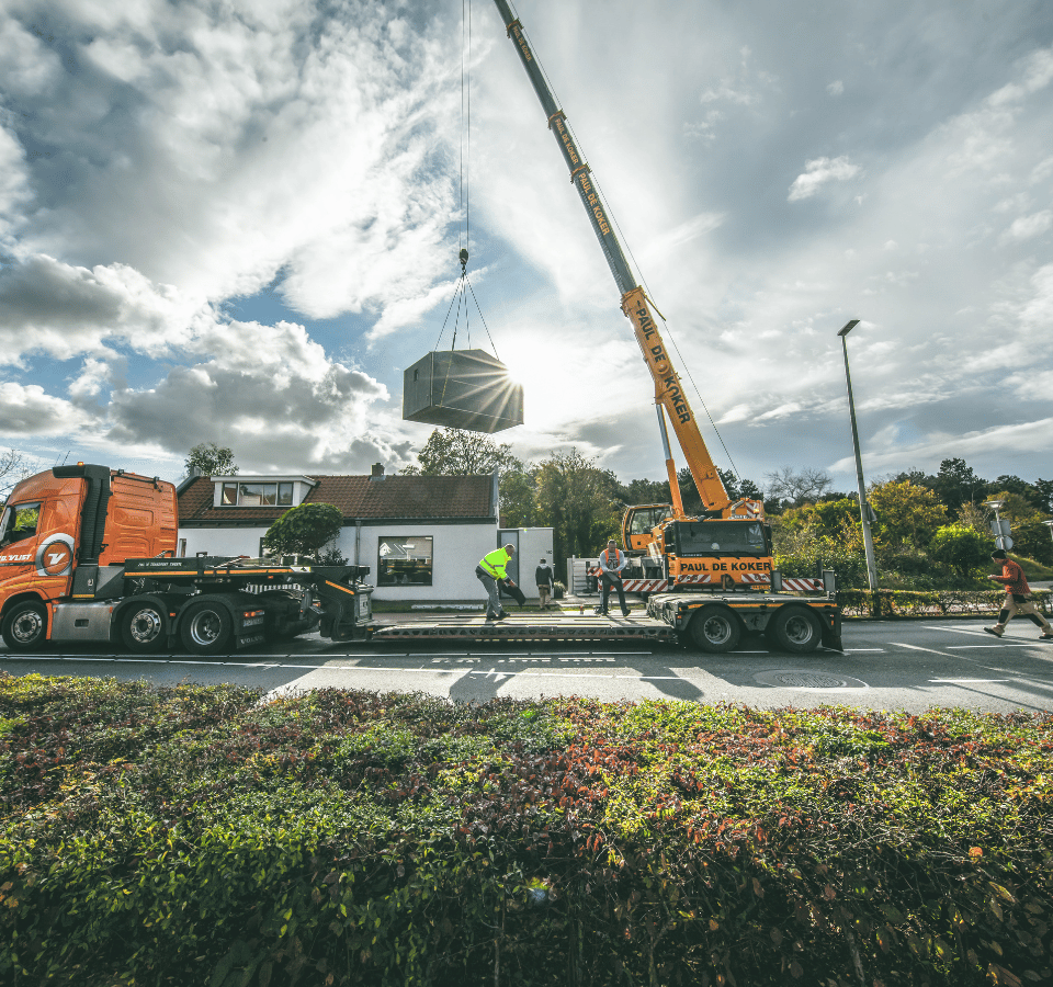 Tiny house delivered by crane from a truck