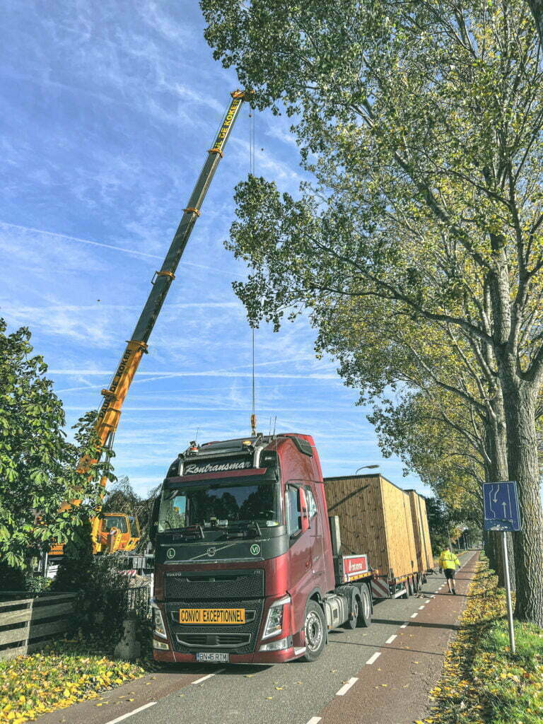 custom design being put on truck by crane