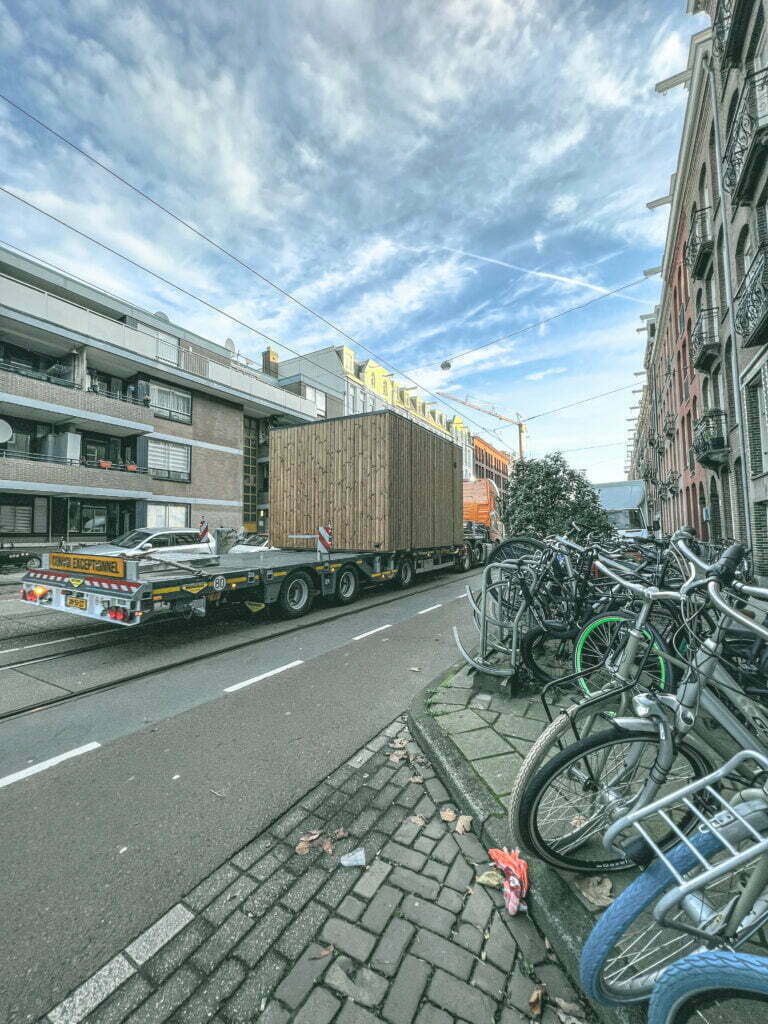 Custom Tiny House on deeploader in busy Amsterdam Street