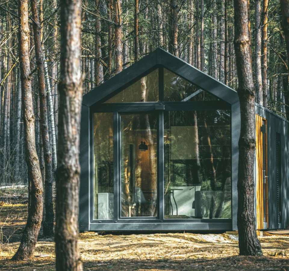 Tiny House in the Woods. Tiny Home Malmö nestled among the trees in the forest on a soft terrain