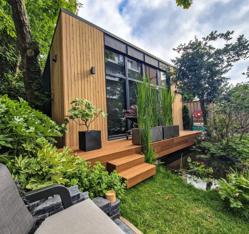 Purchased Elegant Vista Modern Tiny House for Your Garden: A Tranquil Backyard Tiny House Amidst Lush Greenery, Including Trees and Water.