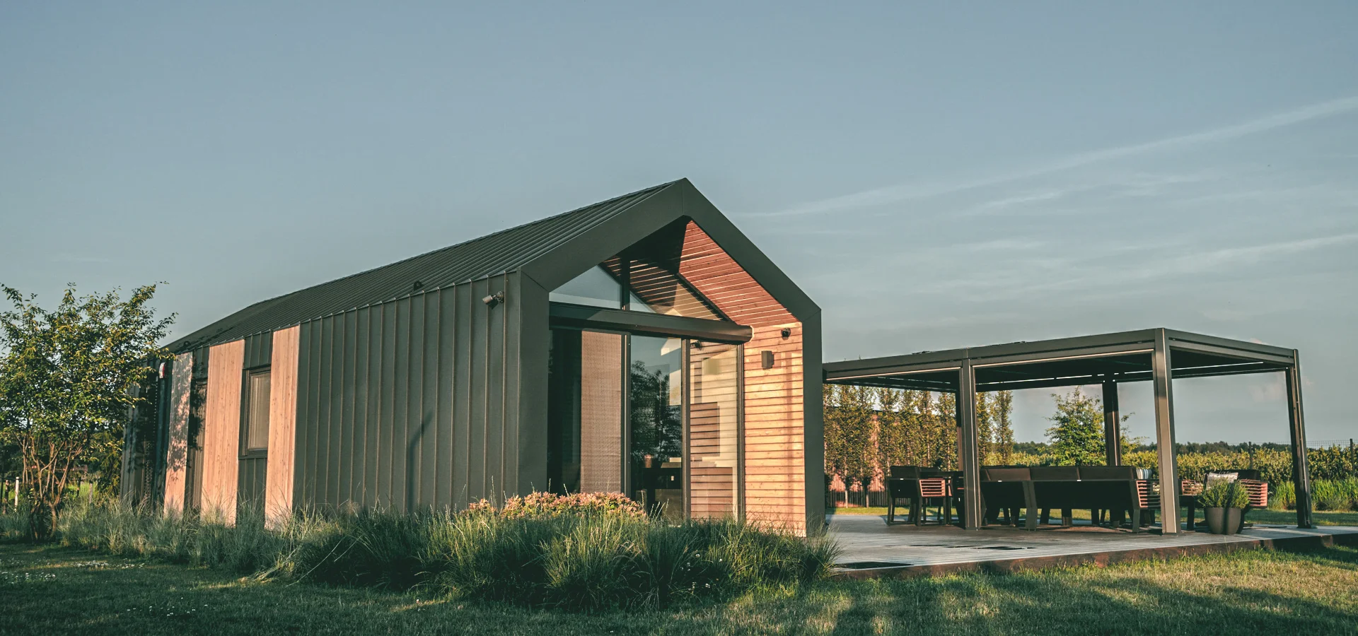Exterior view of stuga tiny house with garden