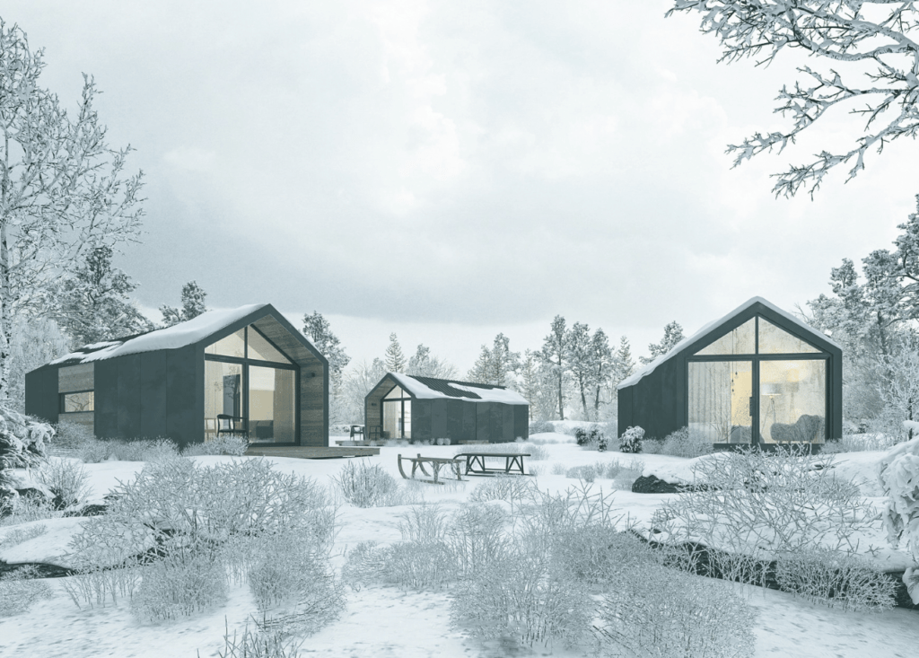 Three tiny houses in the snow with trees, everything covered in white
