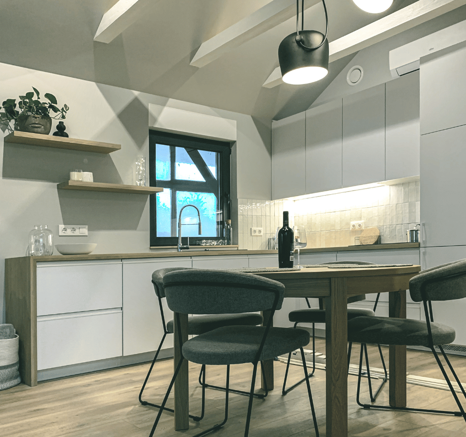 Tiny House dining table, chairs, table, wine bottle, open kitchen.
