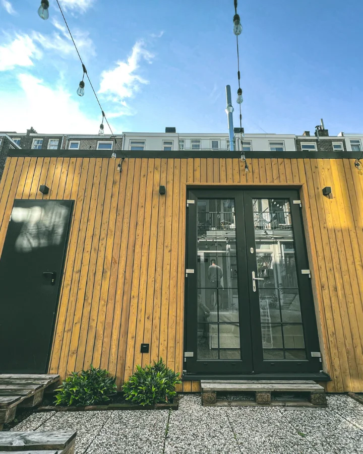 Tiny House in the Backyard, Yellow wood finishing, lamps as garden lighting